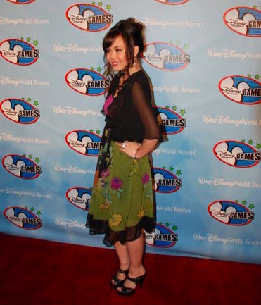 Brenda in a black top and green skirt